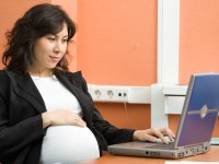A pregnant woman working in the office